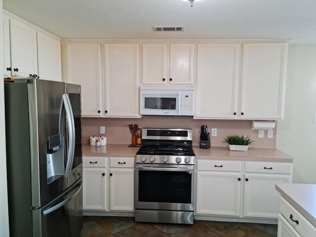 19626 Tularosa Ln, Tomball, TX 77377 - kitchen with stainless steel appliances, light countertops, and white cabinets