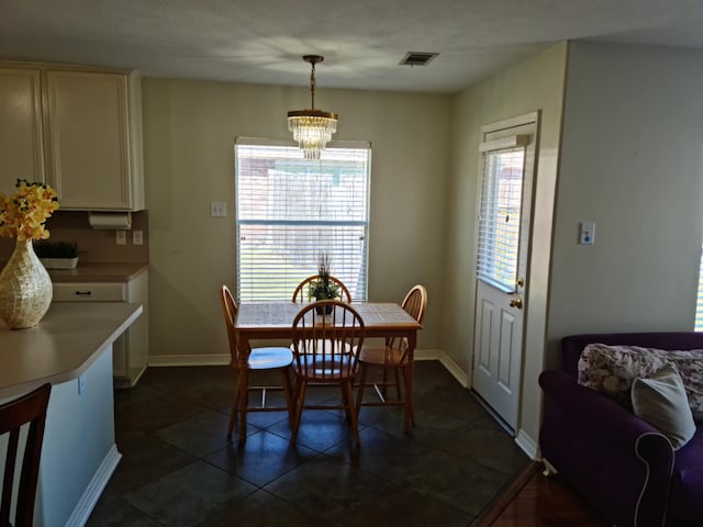 19626 Tularosa Ln, Tomball, TX 77377 - dining room with a chandelier, baseboards, and dark tile patterned flooring