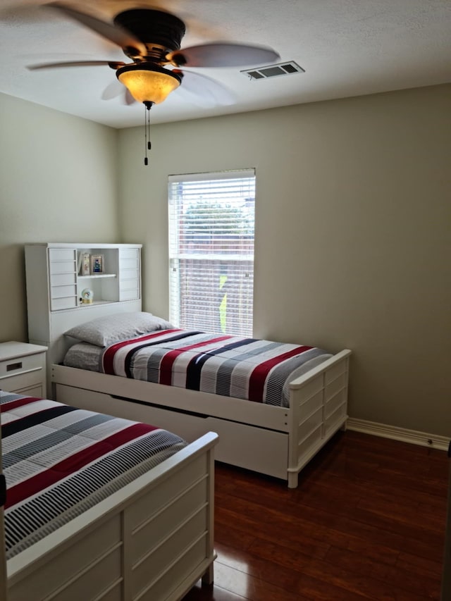 19626 Tularosa Ln, Tomball, TX 77377 - bedroom featuring dark wood-style flooring, a ceiling fan, and baseboards