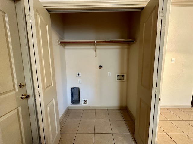 clothes washing area featuring hookup for an electric dryer, light tile patterned flooring, and washer hookup