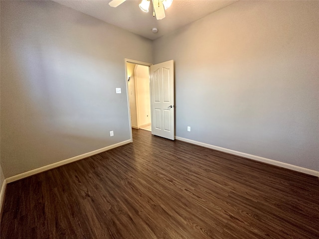 spare room with ceiling fan and dark hardwood / wood-style floors