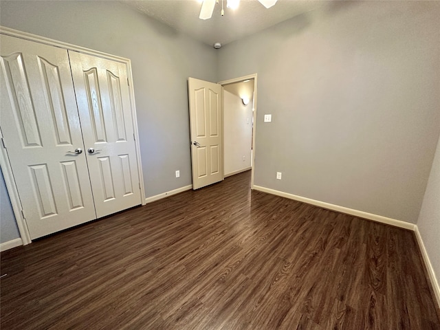 unfurnished bedroom featuring dark hardwood / wood-style floors, a closet, and ceiling fan