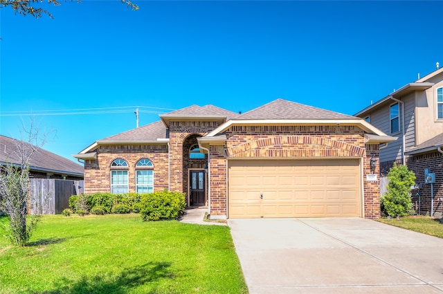 view of front of property featuring a front yard and a garage