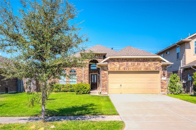 view of front of property featuring a garage and a front lawn