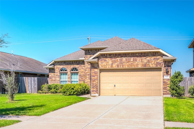 view of front facade featuring a front lawn and a garage