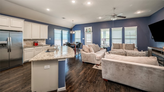 kitchen with white cabinets, decorative light fixtures, plenty of natural light, and stainless steel fridge