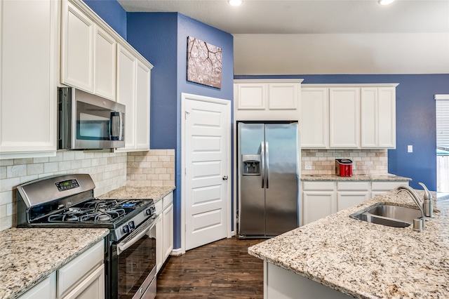 kitchen with appliances with stainless steel finishes, white cabinetry, sink, and dark wood-type flooring