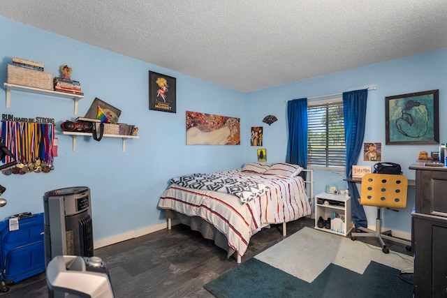 bedroom featuring dark wood-type flooring and a textured ceiling