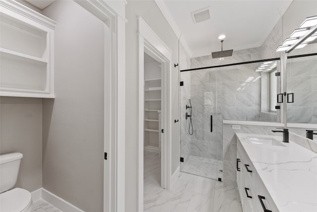 bathroom featuring toilet, a shower with shower door, vanity, and crown molding