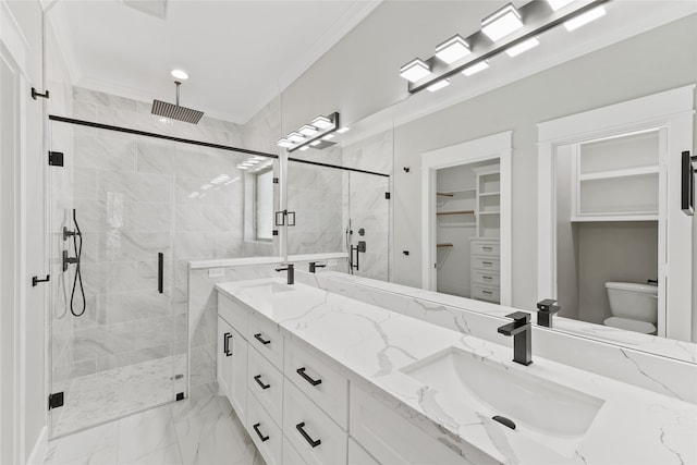 bathroom with vanity, ornamental molding, walk in shower, and toilet