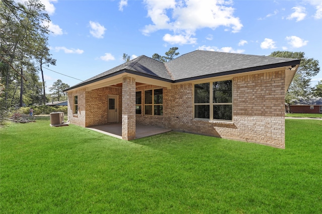 back of property with a yard, a patio area, and central AC unit