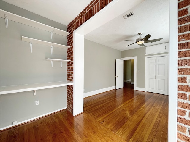 unfurnished room featuring a textured ceiling, hardwood / wood-style flooring, and ceiling fan