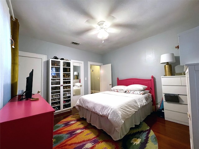 bedroom featuring ceiling fan and dark hardwood / wood-style floors