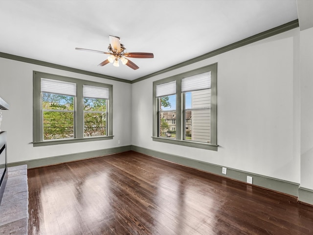 unfurnished room featuring wood-type flooring, crown molding, and plenty of natural light