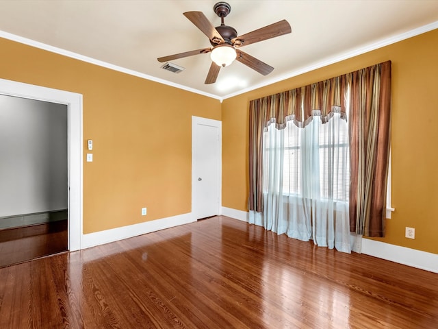 spare room featuring hardwood / wood-style floors, ceiling fan, and crown molding