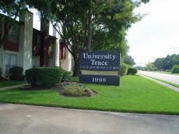 community / neighborhood sign with a lawn