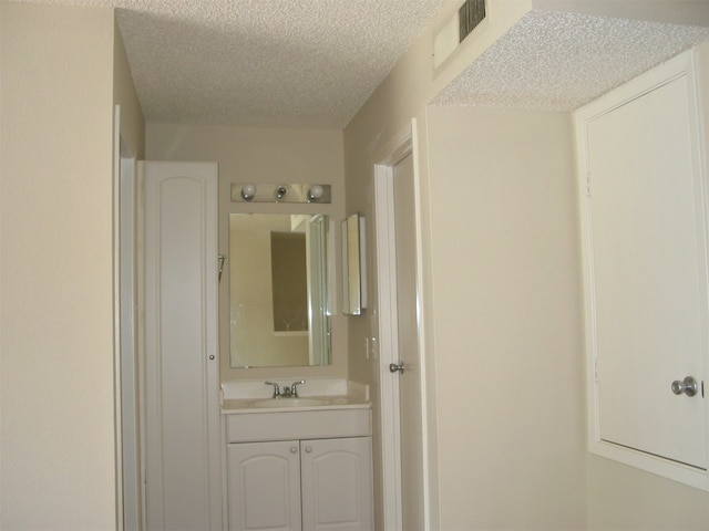 bathroom with vanity and a textured ceiling