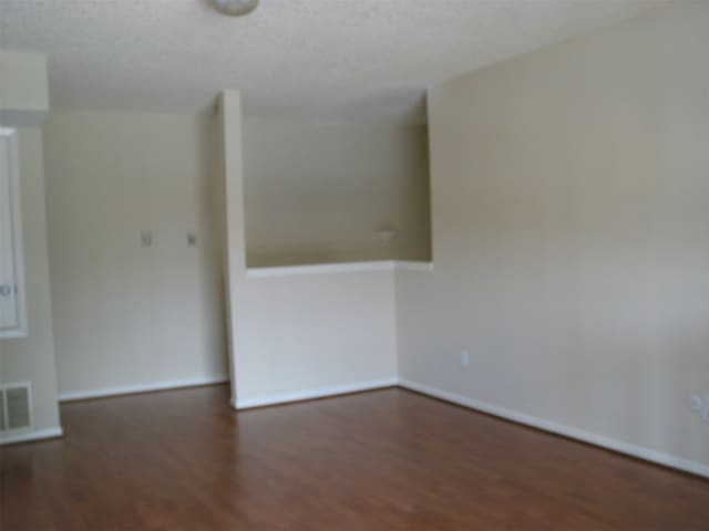 empty room with dark hardwood / wood-style floors