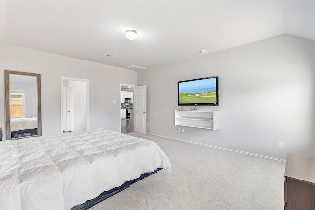 bedroom featuring vaulted ceiling and light carpet