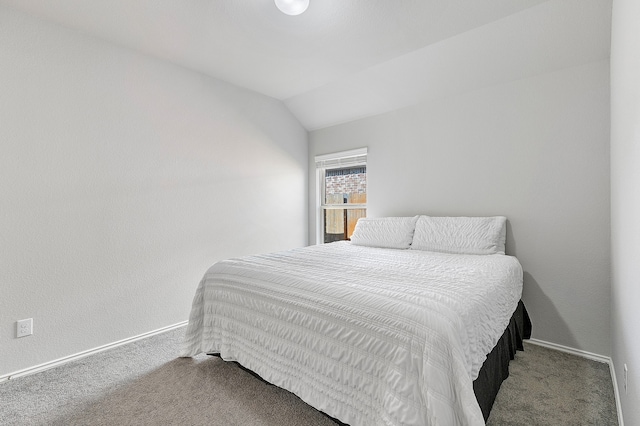 bedroom with lofted ceiling and carpet floors