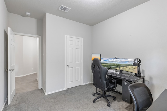 office with light carpet and a textured ceiling