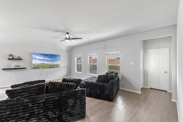 living room featuring light hardwood / wood-style flooring and ceiling fan