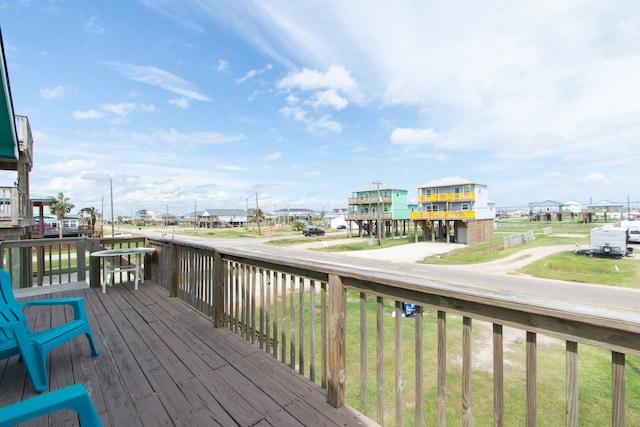 wooden terrace featuring a yard and a water view