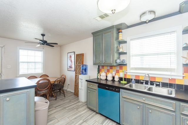 kitchen featuring stainless steel dishwasher, sink, decorative backsplash, and ceiling fan