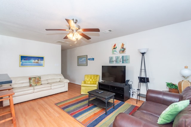 living room with hardwood / wood-style flooring and ceiling fan