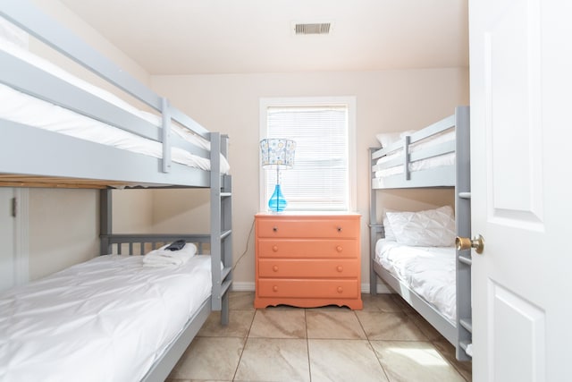 bedroom featuring light tile patterned floors