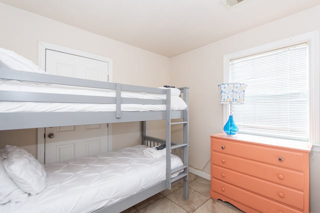 bedroom with light tile patterned floors