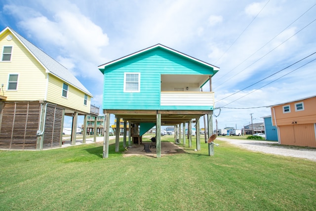 back of house with a lawn