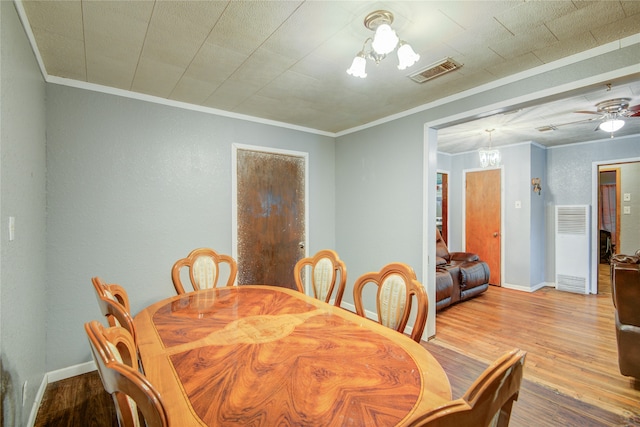 dining area featuring ceiling fan, ornamental molding, and light wood-type flooring