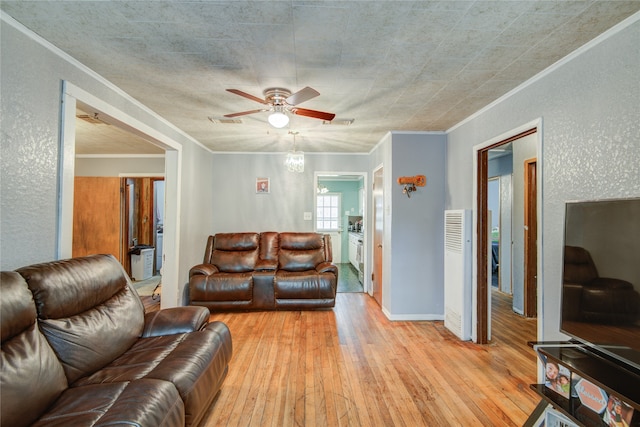 living room with light hardwood / wood-style flooring, ornamental molding, and ceiling fan