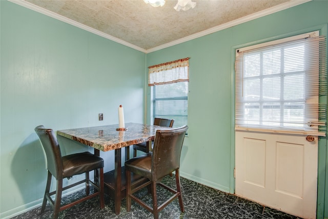 dining space featuring crown molding