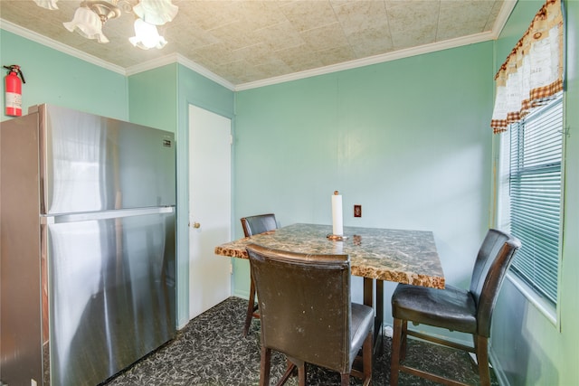 dining area featuring crown molding and dark colored carpet