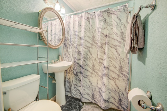 bathroom featuring toilet and a shower with shower curtain