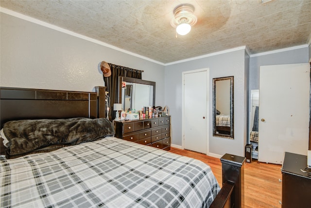 bedroom featuring ornamental molding and hardwood / wood-style floors