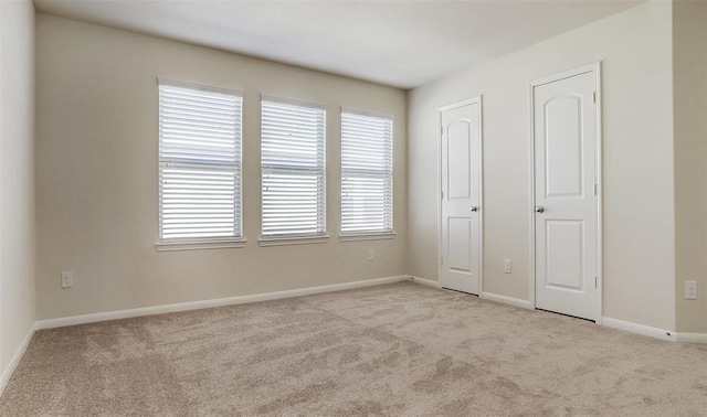 unfurnished bedroom featuring light colored carpet