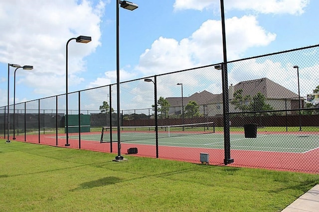 view of sport court featuring a lawn