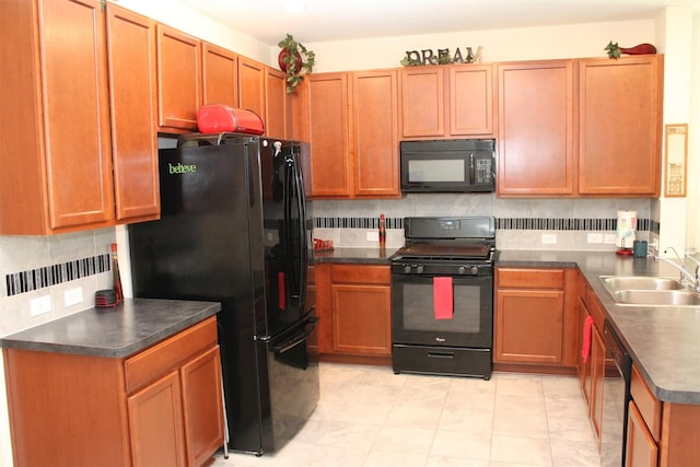 kitchen with black appliances, decorative backsplash, and sink