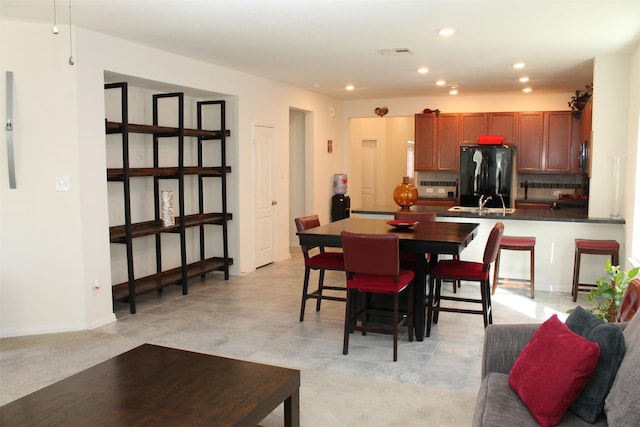 tiled dining room with sink