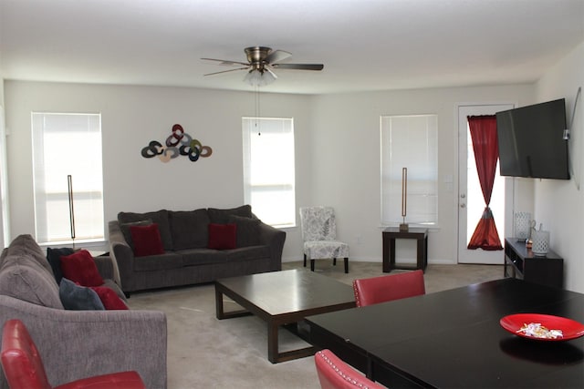 living room featuring a healthy amount of sunlight, light colored carpet, and ceiling fan