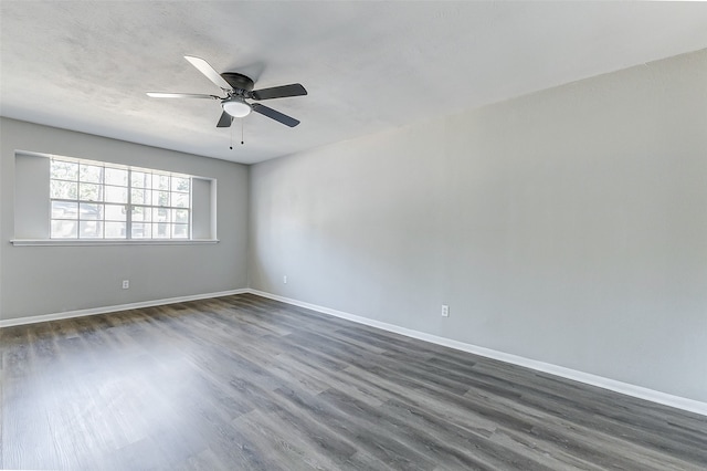 spare room with ceiling fan and dark hardwood / wood-style flooring