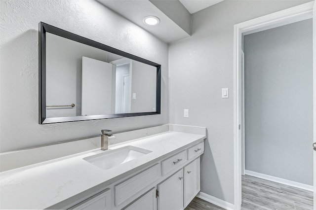 bathroom with vanity and hardwood / wood-style flooring