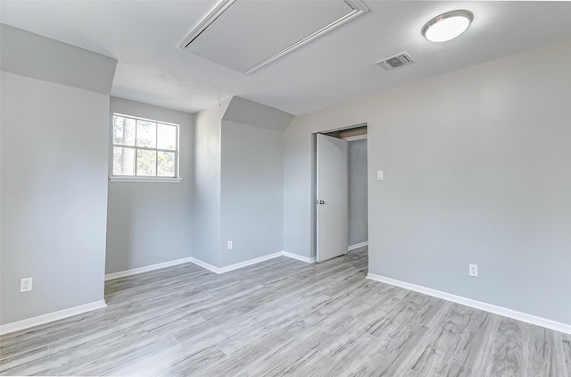 unfurnished room with light hardwood / wood-style flooring