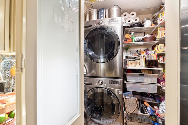 clothes washing area with stacked washer / dryer