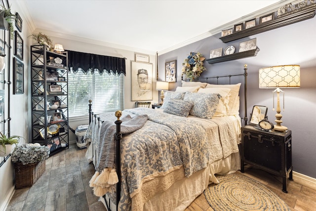 bedroom with hardwood / wood-style floors and crown molding