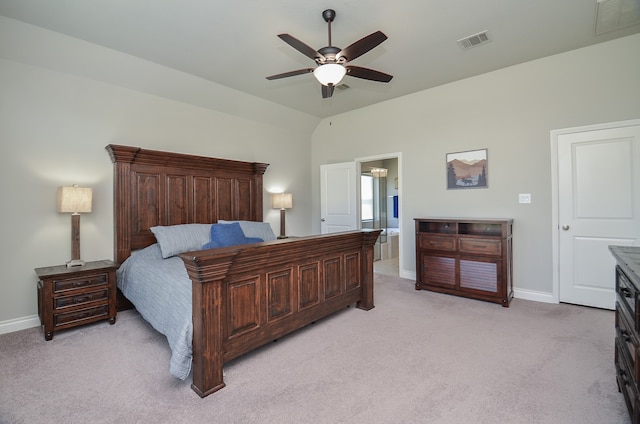 bedroom featuring connected bathroom, vaulted ceiling, light carpet, and ceiling fan