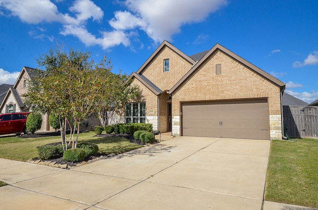 view of front of house with a front yard and a garage